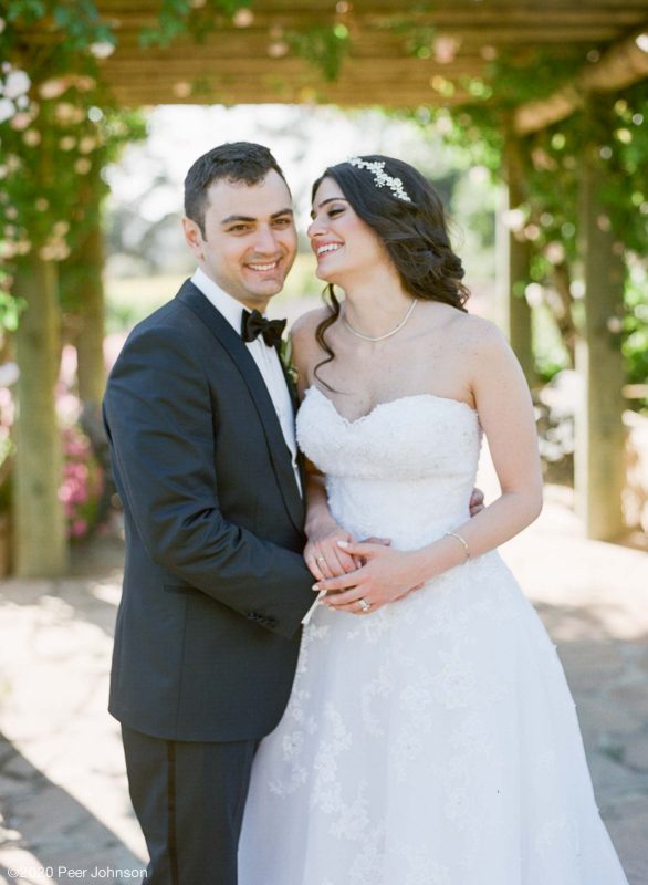 A groom smiles for the camera in Carmel Valley